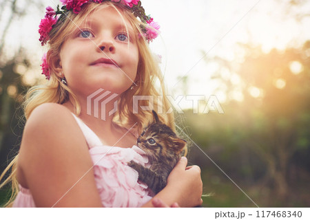 Girl, happy and garden with kitten for love or furry companion for comfort, friendship and growth or development. Kid, flower crown and cute animal in nature with affection, bonding and playing. Girl, happy and garden with kitten for love or furry companion for comfort, friendship and growth or development. Kid, flower crown and cute animal in nature with affection, bonding and playing. 117468340
