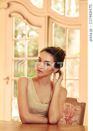 Woman, portrait and luxury in house as fancy, elegant and classy in fashion by window for wealth aesthetic. Female person, style and vintage mansion for gala, dinner or event with confidence or pride 117468470