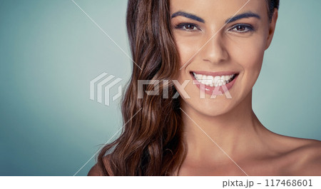 Portrait, mockup or woman with smile or skincare on blue background for beauty, wellness or natural glow. Happy, proud model or face of girl in studio for dermatology, smooth results or facial health 117468601