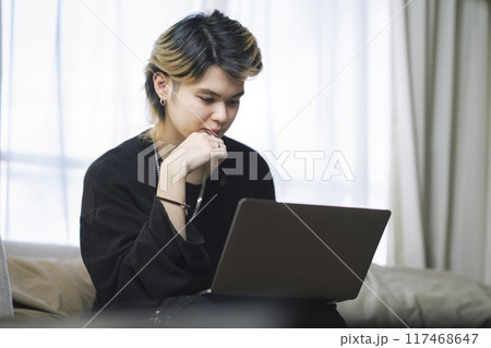 ノートパソコンで作業をする若い男性 117468647