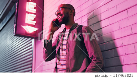 Happy man, conversation and neon light with phone at night for communication outside bar, pub or club. Male person talking with smile in happiness on mobile smartphone for friendly discussion in city Happy man, conversation and neon light with phone at night for communication outside bar, pub or club. Male person talking with smile in happiness on mobile smartphone for friendly discussion in city 117468823
