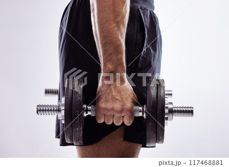 Closeup, man and hand with dumbbell for exercise with muscle development, workout and wellness in studio. Male bodybuilder, training and holding iron weights for strong arms by white background 117468881