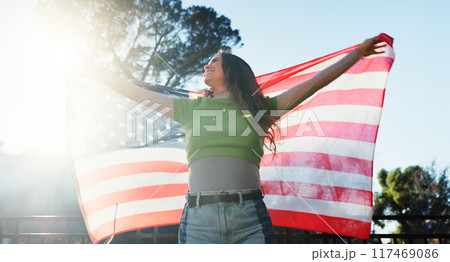 Woman, american flag and happy with celebration outdoor for national holiday, human rights or freedom. Patriot, person or smile for independence, pride or loyalty with confidence, culture or heritage Woman, american flag and happy with celebration outdoor for national holiday, human rights or freedom. Patriot, person or smile for independence, pride or loyalty with confidence, culture or heritage 117469086