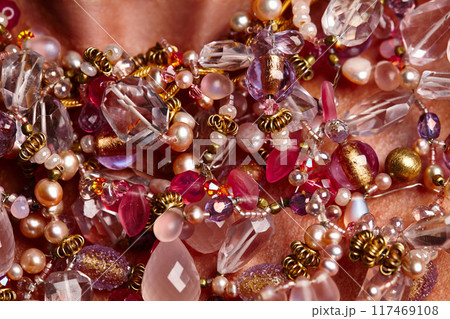 Rich person, closeup and vintage necklace on studio background for fashion, beauty and luxury pearls. Model, wealth and zoom for glamour, gold or designer jewelry, chain and accessory with gemstones 117469108