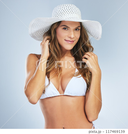 Woman, bikini and portrait in studio for confidence, fashion and beach body with summer in vacation. Female person, swimsuit and happy on white background for health, wellness and holiday with smile 117469139