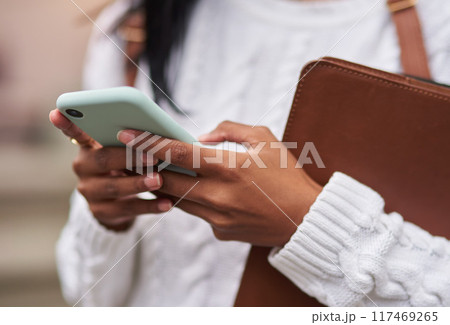 Outdoor, phone and hands of student, girl and research for studying, online and internet on app. Scholarship, university and person in campus with social media, reading news for school or college Outdoor, phone and hands of student, girl and research for studying, online and internet on app. Scholarship, university and person in campus with social media, reading news for school or college 117469265