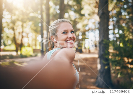 Happy woman, fitness and holding hands with partner for outdoor workout, exercise or hiking in nature. Female person with smile or earphones for music, trekking or walking with pov in forest Happy woman, fitness and holding hands with partner for outdoor workout, exercise or hiking in nature. Female person with smile or earphones for music, trekking or walking with pov in forest 117469408