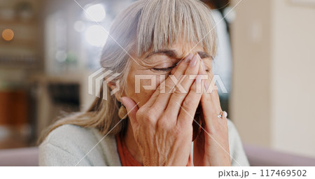 Senior woman, crying and sad in lounge, hand and memory of past, retirement and depression in nursing home. Grandma, lonely and couch of house, remember and elderly person in living room and grief 117469502