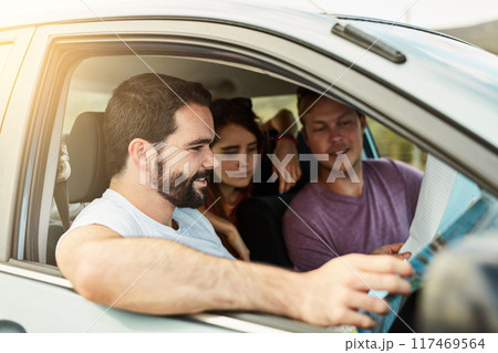 Group, reading map and travel in car on road trip, vacation and planning holiday destination. Friends, happy people and direction guide in transport for journey, adventure and navigation to location 117469564