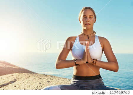 Outdoor, prayer hands and woman with zen for yoga, wellness and spiritual peace in California. Chakra, female yogi and namaste with lotus pose for meditation, relax and mental health by blue sky Outdoor, prayer hands and woman with zen for yoga, wellness and spiritual peace in California. Chakra, female yogi and namaste with lotus pose for meditation, relax and mental health by blue sky 117469760