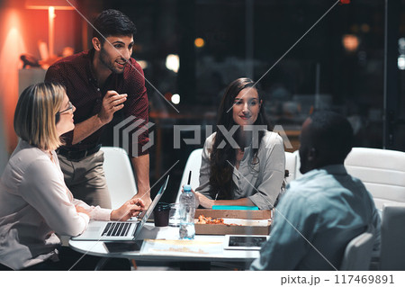 Business people, laptop and problem solving for project at night in office, creative agency and overtime food for design. Teamwork, support and planning in pizza meeting for deadline and discussion 117469891
