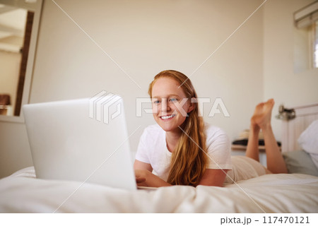 Girl, laptop and social media for networking while on bed, searching and home for browsing for movie. Laugh and smile at streaming site for entertainment, online in bedroom and post blog on website 117470121
