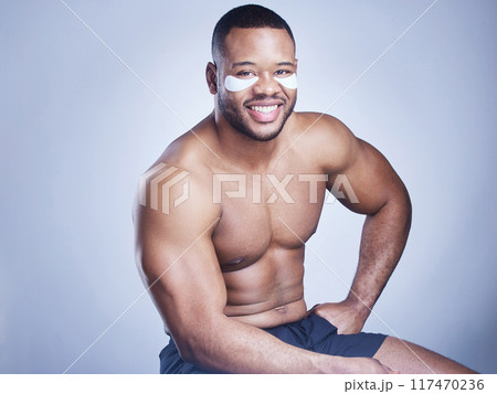 Black man, portrait and eye pads in studio, facial treatment and hydration mask on blue background. Male person, skincare and beauty product for moisture, grooming and patches to smile for cosmetics Black man, portrait and eye pads in studio, facial treatment and hydration mask on blue background. Male person, skincare and beauty product for moisture, grooming and patches to smile for cosmetics 117470236