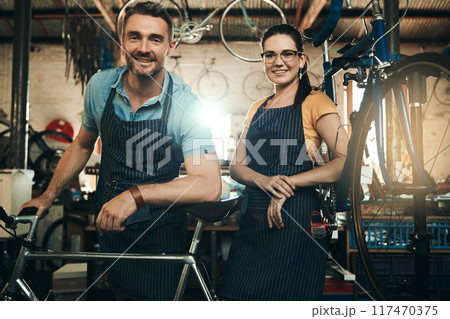 Portrait, people and bicycle shop with repair job of mechanic, technician and maintenance work. Workshop, service and happy business owner with employee and bike for fixing with apron and pride Portrait, people and bicycle shop with repair job of mechanic, technician and maintenance work. Workshop, service and happy business owner with employee and bike for fixing with apron and pride 117470375