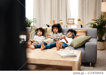 Relax, children and eating popcorn on sofa in lounge, tv or bonding by streaming movie for entertainment on holiday. Boy, family and snack food together for video subscription with childhood film Relax, children and eating popcorn on sofa in lounge, tv or bonding by streaming movie for entertainment on holiday. Boy, family and snack food together for video subscription with childhood film 117470454