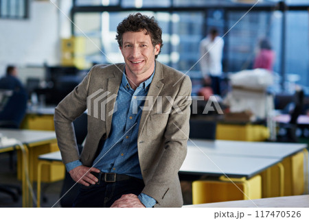 Business man, portrait and smile in office with confidence for company, work and career. Male person, professional and happy in workplace at consultant startup by desk, about us or entrepreneur 117470526