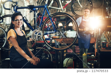 People, portrait and bicycle mechanic with teamwork for inspection, maintenance or small business at repair shop. Man, woman or cycling engineers working on bike with tools or equipment at workshop People, portrait and bicycle mechanic with teamwork for inspection, maintenance or small business at repair shop. Man, woman or cycling engineers working on bike with tools or equipment at workshop 117470533