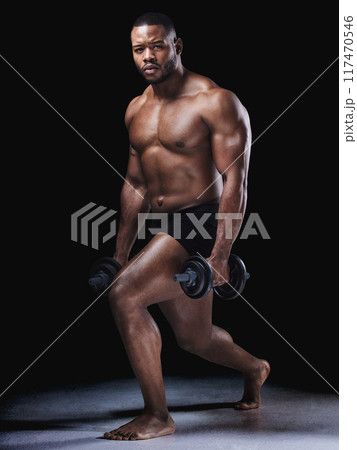 Fitness, portrait and black man in studio with dumbbells for training, workout or weightlifting on dark background. Body, strong and bodybuilder with weights for muscle growth, wellness or squat 117470546