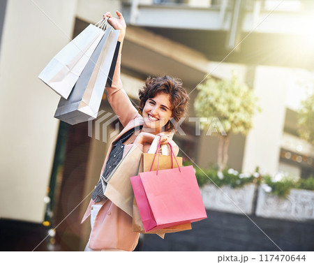 Woman, portrait and shopping bags or excited in city with sale for retail promotion and store discount. Shopper, person and customer with package outdoor for celebration, gift or fashion deal in town Woman, portrait and shopping bags or excited in city with sale for retail promotion and store discount. Shopper, person and customer with package outdoor for celebration, gift or fashion deal in town 117470644