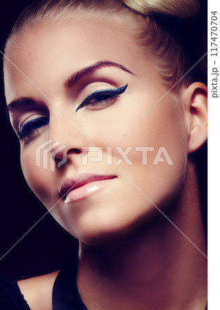 Eyeliner, woman and portrait in studio, for beauty, cosmetics and foundation for confidence. Model, female person and glamour or luxury by black background for creativity, design and pride for art Eyeliner, woman and portrait in studio, for beauty, cosmetics and foundation for confidence. Model, female person and glamour or luxury by black background for creativity, design and pride for art 117470704