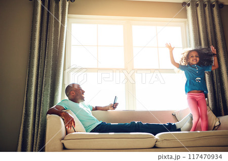 Black man, phone picture and girl on couch with jumping for weekend fun together and post for social media in home. Young child, African father and mobile video with playing on sofa for love bonding Black man, phone picture and girl on couch with jumping for weekend fun together and post for social media in home. Young child, African father and mobile video with playing on sofa for love bonding 117470934