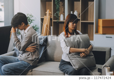 Offended couple ignoring each other after quarrel indoors, selective focus. Relationship problems Offended couple ignoring each other after quarrel indoors, selective focus. Relationship problems 117472424