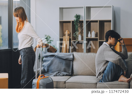 Offended couple ignoring each other after quarrel indoors, selective focus. Relationship problems 117472430