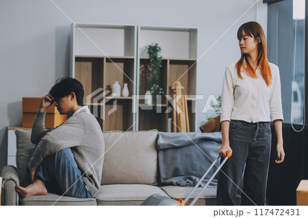 Offended couple ignoring each other after quarrel indoors, selective focus. Relationship problems 117472431
