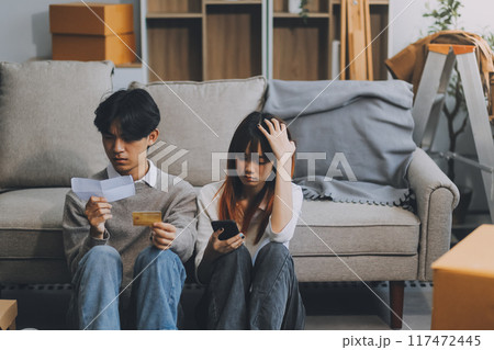 Worried annoyed young husband wife using phone credit card dissatisfied with interrupted wifi internet connection slow bad app work. Angry family couple bank clients unable to pay online check balance 117472445