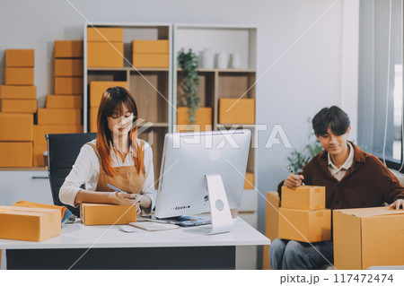 Small business owners couple entrepreneurs working with parcel, e-business, marketing, online shop, sme, entrepreneurs Small business owners couple entrepreneurs working with parcel, e-business, marketing, online shop, sme, entrepreneurs 117472474