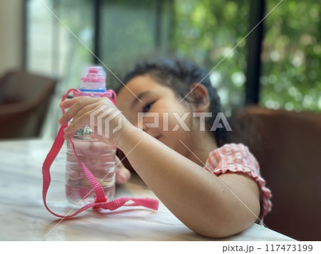 asian child girl drinking water from bottle asian child girl drinking water from bottle 117473199