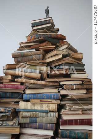 Tower of tomes with a figure on top 117475687