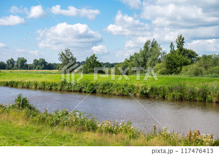 Green banks of the River Ochtum at the Kladdinger Wiesen at the borders of Bremen, Germany Green banks of the River Ochtum at the Kladdinger Wiesen at the borders of Bremen, Germany 117476413