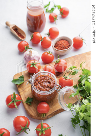 Salsa sauce is a traditional Mexican sauce with tomatoes and hot peppers on a light background  117478514
