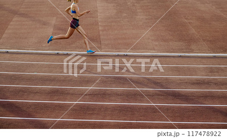 woman athlete running middle distance race in stadium 117478922