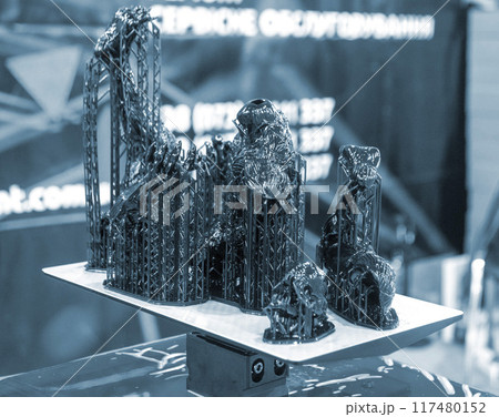 Black model with supports printed on 3D printer close-up. Part of object created on 3D printer from hardened rubber under influence of ultraviolet light. SLA 3D printing technology. Stereolithography 117480152