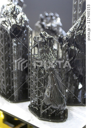 Model of hand printed on a 3D printer from black rubber, close-up. Part of an object created on a 3D printer from hardened rubber under the influence of ultraviolet light. SLA 3D printing technology. 117480153