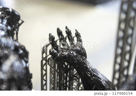 Model of hand printed on a 3D printer from black rubber, close-up. Part of an object created on a 3D printer from hardened rubber under the influence of ultraviolet light. SLA 3D printing technology. 117480154