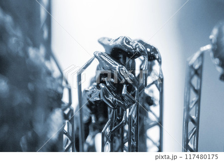 Model of hand printed on a 3D printer from black rubber, close-up. Part of an object created on a 3D printer from hardened rubber under the influence of ultraviolet light. SLA 3D printing technology. 117480175
