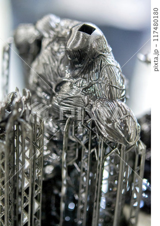 Black model with supports printed on 3D printer close-up. Part of object created on 3D printer from hardened rubber under influence of ultraviolet light. SLA 3D printing technology. Stereolithography Black model with supports printed on 3D printer close-up. Part of object created on 3D printer from hardened rubber under influence of ultraviolet light. SLA 3D printing technology. Stereolithography 117480180