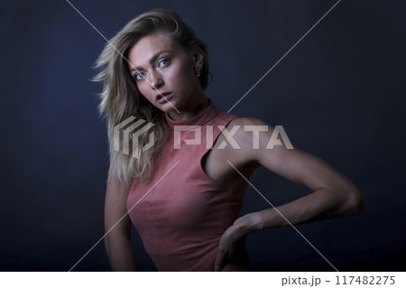portrait of a young attractive woman on a dark background portrait of a young attractive woman on a dark background 117482275