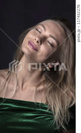portrait of a young attractive woman on a dark background 117482276