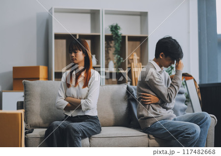 Offended couple ignoring each other after quarrel indoors, selective focus. Relationship problems 117482668