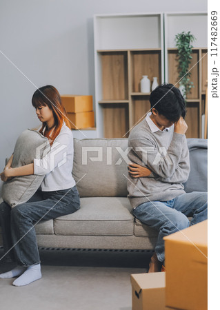 Offended couple ignoring each other after quarrel indoors, selective focus. Relationship problems Offended couple ignoring each other after quarrel indoors, selective focus. Relationship problems 117482669