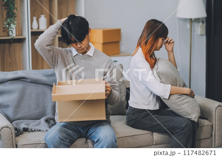 Offended couple ignoring each other after quarrel indoors, selective focus. Relationship problems 117482671