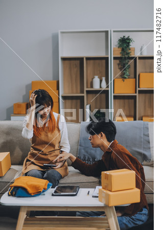 Small business owners couple entrepreneurs working with parcel, e-business, marketing, online shop, sme, entrepreneurs 117482716