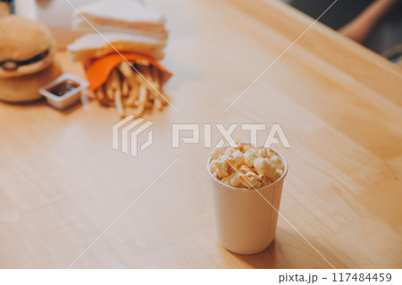 A woman holding a bowl of popcorn 117484459