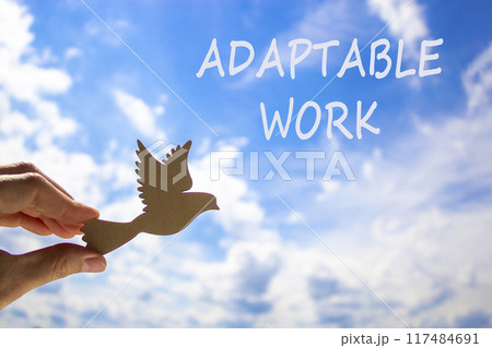 Adaptable work symbol. Concept words Adaptable work on beautiful sky. Beautiful blue sky cloud background. Businessman hand with wooden bird. Business Adaptable work concept. Copy space. Adaptable work symbol. Concept words Adaptable work on beautiful sky. Beautiful blue sky cloud background. Businessman hand with wooden bird. Business Adaptable work concept. Copy space. 117484691