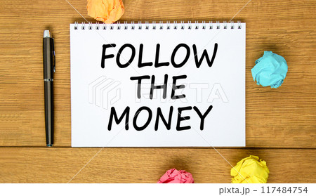 Follow the money symbol. Concept words Follow the money on beautiful white note. Beautiful wooden background. Black pen. Colored paper. Business and follow the money concept. Copy space. 117484754