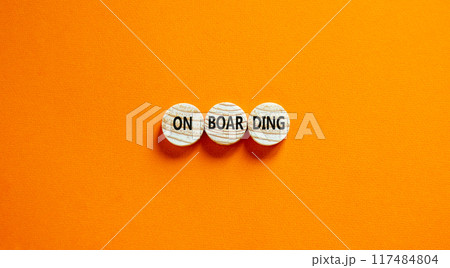 Onboarding success symbol. Concept word Onboarding on wooden circles. Beautiful orange background. Business onboarding success concept. Copy space. 117484804